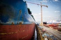 A large tanker kargo ship is being renovated and painted in shipyard dry dock Royalty Free Stock Photo