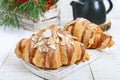 Large tasty croissants with almond flakes on a white wooden background. French pastries.