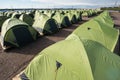 A large number of tents on a sandy beach, lined up strictly in a Royalty Free Stock Photo