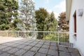 Large terrace in country house with with stone tiled floor, big trees view Royalty Free Stock Photo