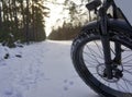 Large Thick Front Wheel of a Fat Bike on a Snow-Covered Path, Cycling Tour Germany Royalty Free Stock Photo