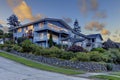 Large three story tall blue house with summer landscape and rock wall. Royalty Free Stock Photo