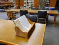 Large thumb indexed dictionary in a wooden bookstand