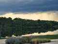 Large thunderstorm forming at Lake Olathe over the forest in Olathe city, Kansas