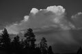 Tall Thunderstorm Dropping Rain At Sunset.