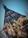 Imposing half-timbered building in an oblique camera pose with grasses in the foreground