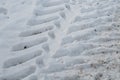 Large tire tracks in a snowy road