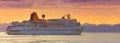 Large tourist cruise ship in the Pacific Ocean bay at sunset