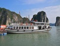 Large Tourist Junk Boat without sail docking at Fishing Village in Halong Bay