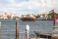 A large tourist ship with tourists moves along the Dubai Creek in Dubai city, United Arab Emirates