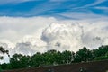 Massive distant towering cumulus clouds developing into storms