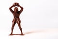 Large toy figures of primitive people on a white background Royalty Free Stock Photo