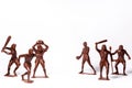 Large toy figures of primitive people on a white background Royalty Free Stock Photo