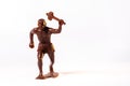 Large toy figures of primitive people on a white background Royalty Free Stock Photo