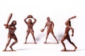 Large toy figures of primitive people on a white background