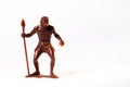 Large toy figures of primitive people on a white background