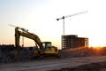 Large tracked excavator on a construction site against the background of the  awesome sunset. Royalty Free Stock Photo
