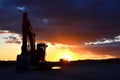 Large tracked excavator on a construction site against the background of the  awesome sunset. Royalty Free Stock Photo
