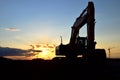 Large tracked excavator on a construction site against the background of the  awesome sunset. Royalty Free Stock Photo