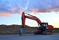 Large tracked excavator on a construction site background of the  awesome sunset. Royalty Free Stock Photo