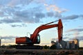 Large tracked excavator on a construction site background of the  awesome sunset. Royalty Free Stock Photo