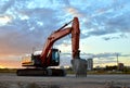 Large tracked excavator on a construction site background of the  awesome sunset. Royalty Free Stock Photo