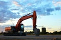 Large tracked excavator on a construction site background of the  awesome sunset. Royalty Free Stock Photo