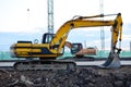 Large tracked excavator on a construction site. Road repair, asphalt replacement. Royalty Free Stock Photo