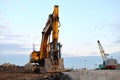 Large tracked excavator on a construction site. Road repair, asphalt replacement.  Loading of stone and rubble for its processing Royalty Free Stock Photo