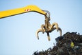 Large tracked excavator working a steel pile