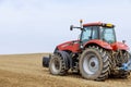 Large tractor on the field. Sowing of grain, vegetable crops.