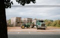 Large tractor hauling several large boxes in an open field in Hendersonville