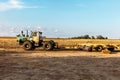 A large tractor is parked in a field Royalty Free Stock Photo
