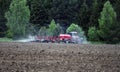 Large tractor with plow plows field before spring sowing of crops. tractor with harrow drives across plowed field and levels