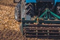 Large tractor pulling a plow and plow the field, remove the remnants of the previously beveled corn.