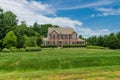 Large traditional red brick colonial house on a green lawn in Virginia Royalty Free Stock Photo