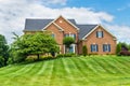 Large traditional red brick colonial house on a green lawn in Virginia Royalty Free Stock Photo