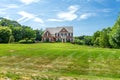 Large traditional red brick colonial house on a green lawn in Virginia Royalty Free Stock Photo