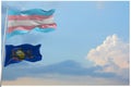 large Transgender Pride flag and flag of Pennsylvania state, USA waving in wind at cloudy sky. Freedom and love concept. Pride