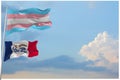 large Transgender Pride flag and flag of Iowa state, USA waving in wind at cloudy sky. Freedom and love concept. Pride month.