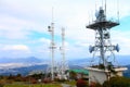 The tower is located on a high mountain with white clouds. Royalty Free Stock Photo