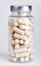 Large transparent gelatin capsules with powder in transparent plastic bottle Royalty Free Stock Photo