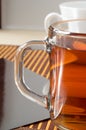 Large transparent glass mug with tea