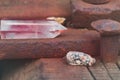 Large transparent mystical faceted crystal of colored pink amethyst, chalcedony on a rails on industrial background close-up