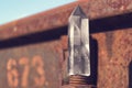 Large transparent mystical faceted crystal of white quartz on a rails on industrial background close-up. A wonderful mineral