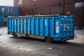 A large, transport worthy iron container, the blue dumpster for managing waste