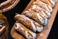 A large tray of Italian dessert cannoli with a cream filling and chocolate chips