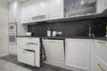 Large white modern domestic kitchen furniture, drawers retracted