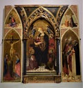 Large triptych, probably on wood, depicting in the central altarpiece the Madonna with the baby Jesus in her arms, in the gallery