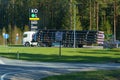 A large truck is driving along the highway, transporting metal pipes.